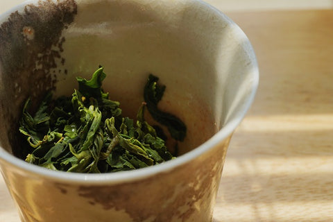 a close up of a coffee cup sitting on top of a wooden table