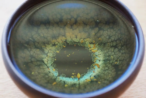 a close up of a coffee cup sitting on top of a wooden table