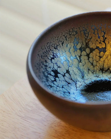 a close up of a coffee cup sitting on top of a wooden table