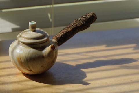 a close up of a coffee cup sitting on top of a wooden table