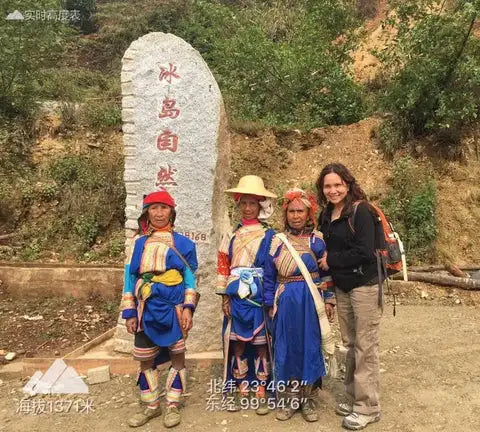 The stone marker stands tall with engraved chinese characters and coordinates, its surface weathered by time.