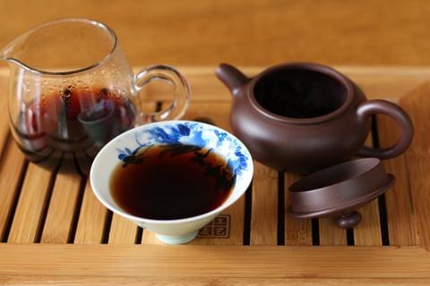 a close up of a coffee cup sitting on top of a wooden table