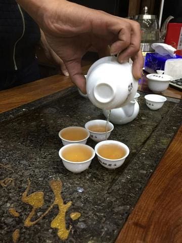 a close up of a coffee cup sitting on top of a wooden table