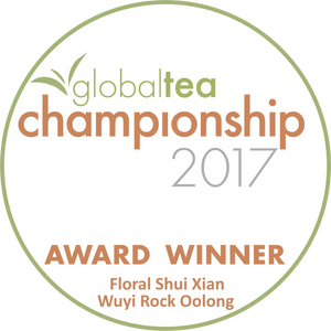 Circular white award badge with green and orange text, featuring the ’global tea championship 2017’’ logo and identifying ’floral shui xian wuyi rock oolong’ as the award winner.