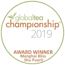 The circular white and green global tea championship 2019 award badge with brown text.